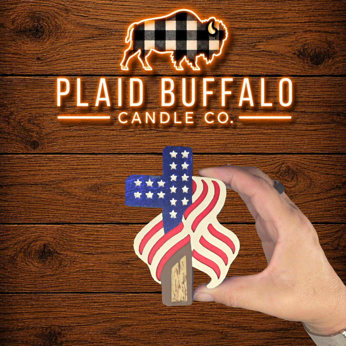 Handmade American flag cross car freshener featuring red, white, and blue colors with a wood-look cross and flowing flag design.